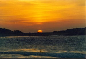 Orange sunrise over beach and ocean