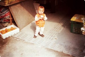 Young boy eating red apple