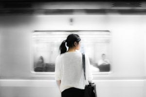 Woman patiently waiting for train.