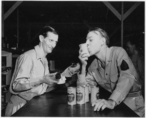 Pictures of Americans drinking beer. One man is kissing the beer can.