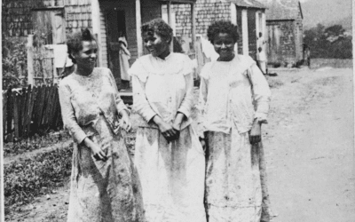 Three native Puerto Rican women in front of their hut houses