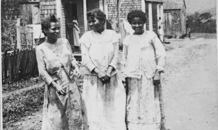 Three native Puerto Rican women in front of their hut houses