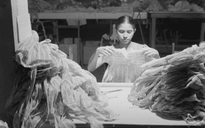 A woman makes dresses in a needlework factory in San Juan