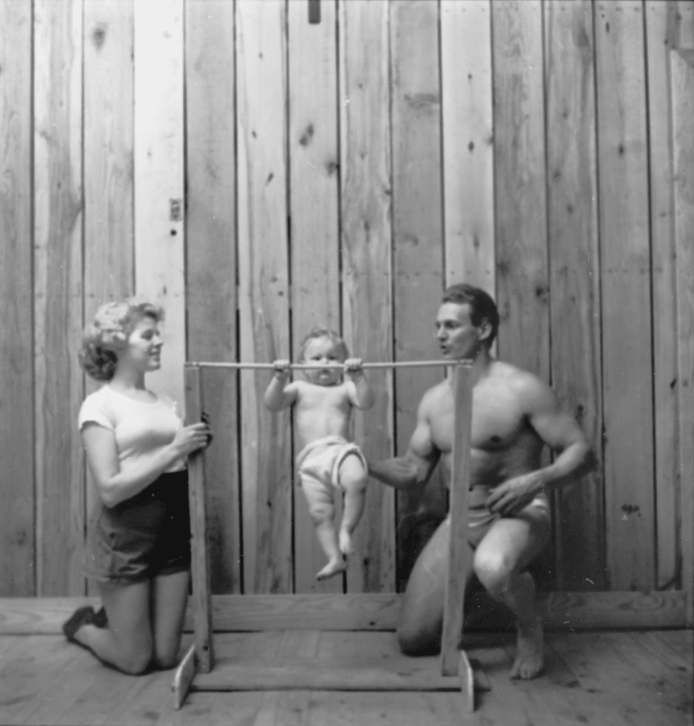 A photograph by Stanley Kubrick showing Bodybuilder Gene Jantzen with wife Pat, and eleven-month-old son Kent