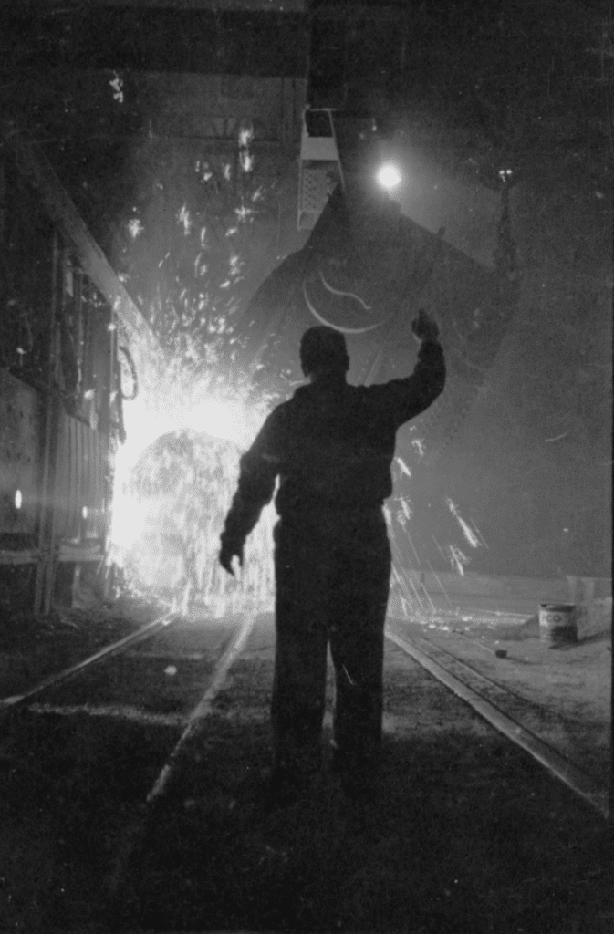 A picture by photographer Stanley Kubrick showing a worker in a steel meel