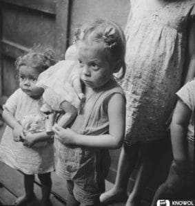 Children from La Perla, the slum area of San Juan Puerto Rico. Two small girls, each clutching a doll.