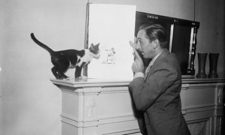 Walt Disney Showing a Picture of Mickey Mouse to a Cat